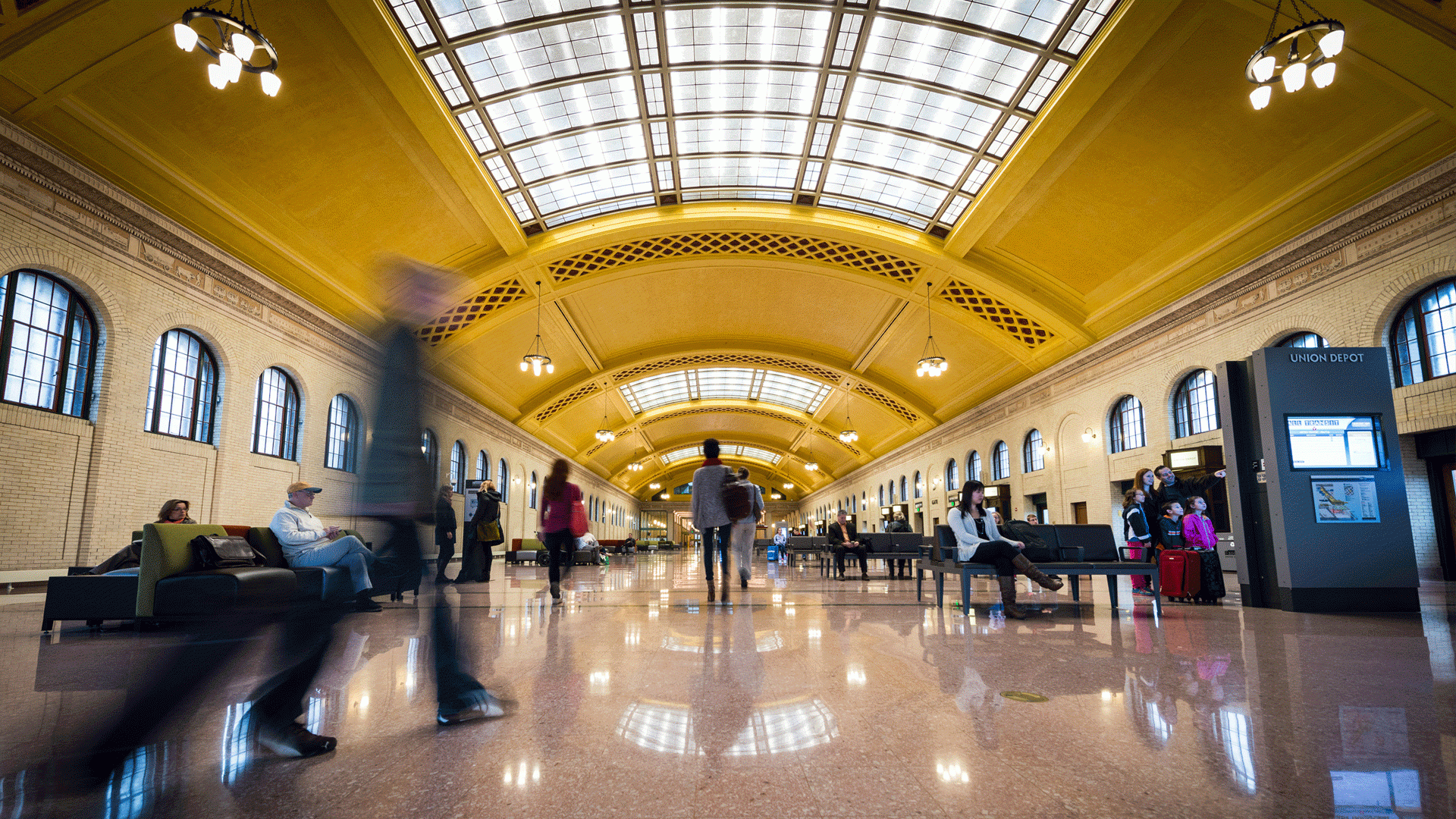 Visitors sit on benches and walk through Union Depot in Saint Paul, MN
